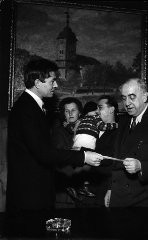 Tue 03, 1953 - James Mason gives a cheque from the International Rescue Committee to Ernst Reuter the Major of Western Berlin for the for Eastern refugee fund - a refugee couple with their child seen in the background