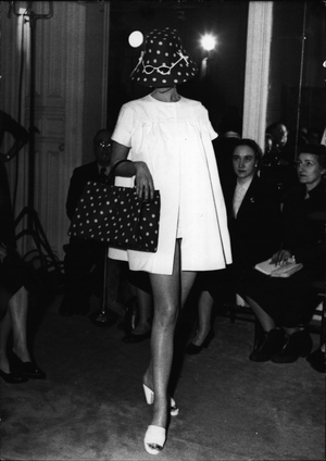 Jan. 01, 1954 - Jacques Faith Introduces Fashion” Gags” In Fashion Preview: A very unusual hat for the Sea side which completely covers the face. A pair of Sun glasses decorated the brim. A large beach bag to match, Red Material with White Polka Dots