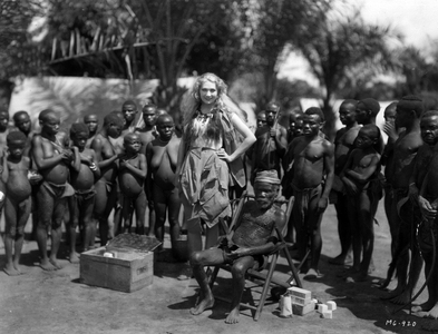 09/09/1930 comedian Edwina Booth (1904-1991), filming for the film “Trader Horn”” posing among a tribe of pygmees, Africa