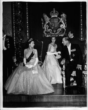 May 05, 1954 - The Royal Visit To Malta.. Queen Attends The Governor's Ball.. Keystone Photo Shows: - With Lady Pamela Mountbatten one of the Ladies-in-waiting in centre - H.M. The Queen has a few words with her husband the Duke of Edinburgh as they watched a performance of the” Maltija” a Native Maltese dance - during the Governor's Ball in Malts