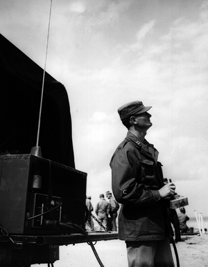 Aug. 08, 1954 - Demonstration of the US Army's new 75 mm skysweeper anti-aircraft gun: The United States Army's new 75 mm Skysweeper, a large caliber automatic anti-aircraft artillery weapon, was fired at radio controlled and towed targest before High ranking British Army officials and members os the press, at Weybourne, Norfolk, today. The new gun which can find and track approaching aircraft as far away as 15 miles, is capable of firing on and defeating air targets as far away as four miles. The weapon equipped with radar, computer and gun all on one carriage, operates day or night regardless of weather conditions, even when aircraft are invisible in a blanketing fog