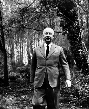 Portrait of designer Christian Dior walking through the woods around 1955 Photography