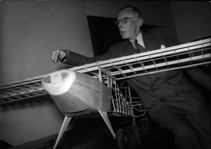 Jan. 20, 1954 - Prof. Julius Krauss became the first new chair of the Technical College of Munich for Plane Construction in the post war period. He is shown here in the lecture hall with a model of an American Piper-Cub-Machine for two people