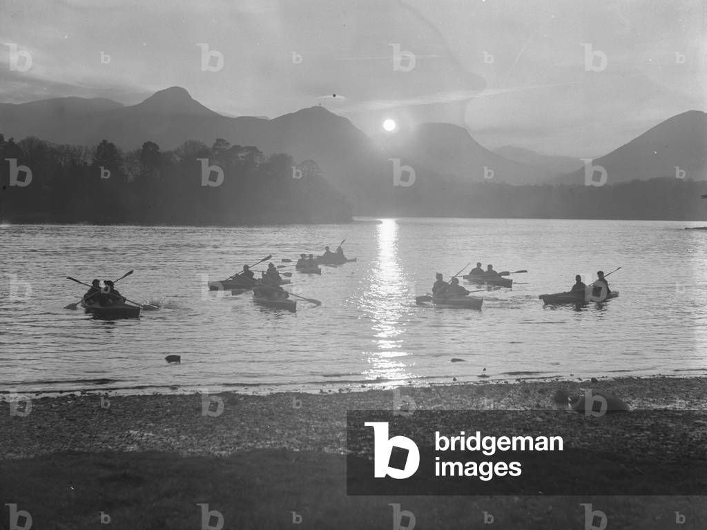 A view of people canoeing on Derwentwater at either sun rise or sun set, 1930s-60s (b/w photo)