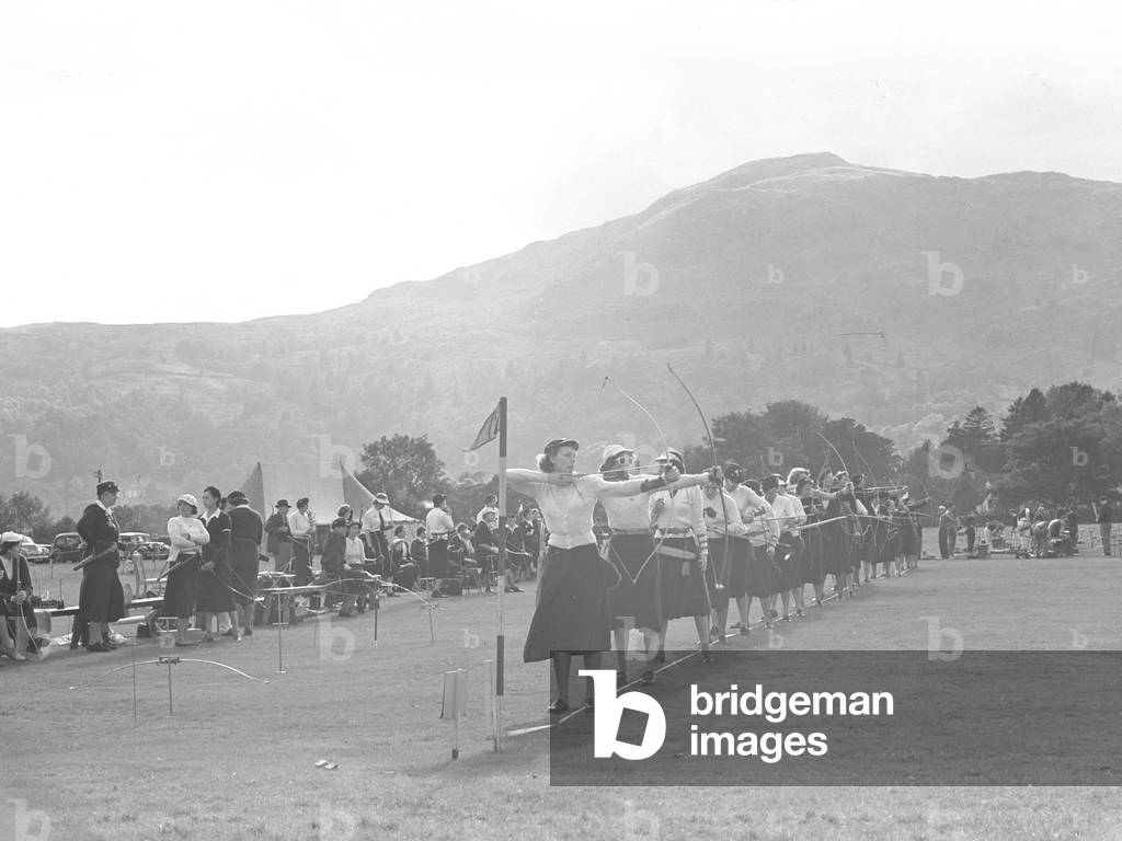 Women archers loosing arrows from the shooting line, 1930s-60s (b/w photo)