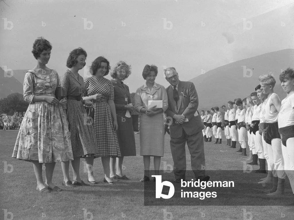 Judges inspecting line of young wrestlers, 1930s-60s (b/w photo)