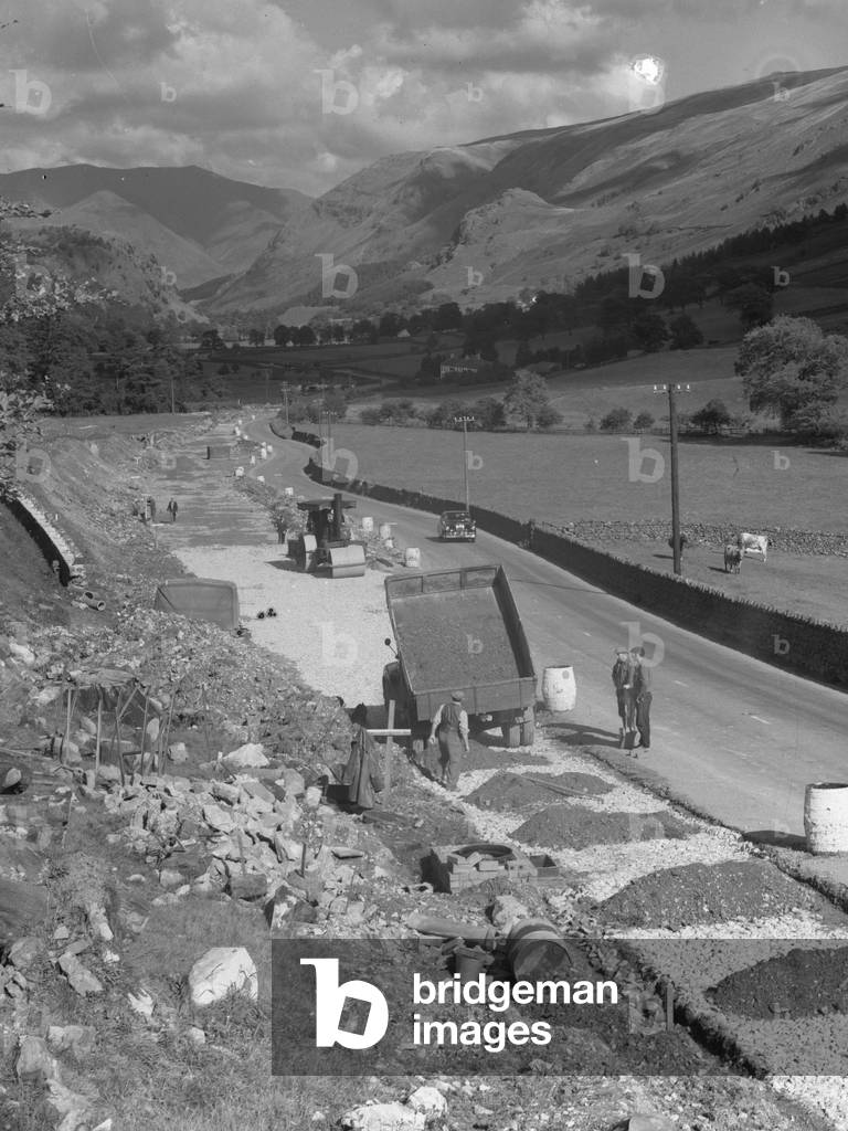 A view of workmen, truck and roller in the process of making a new road, 1930s-60s (b/w photo)