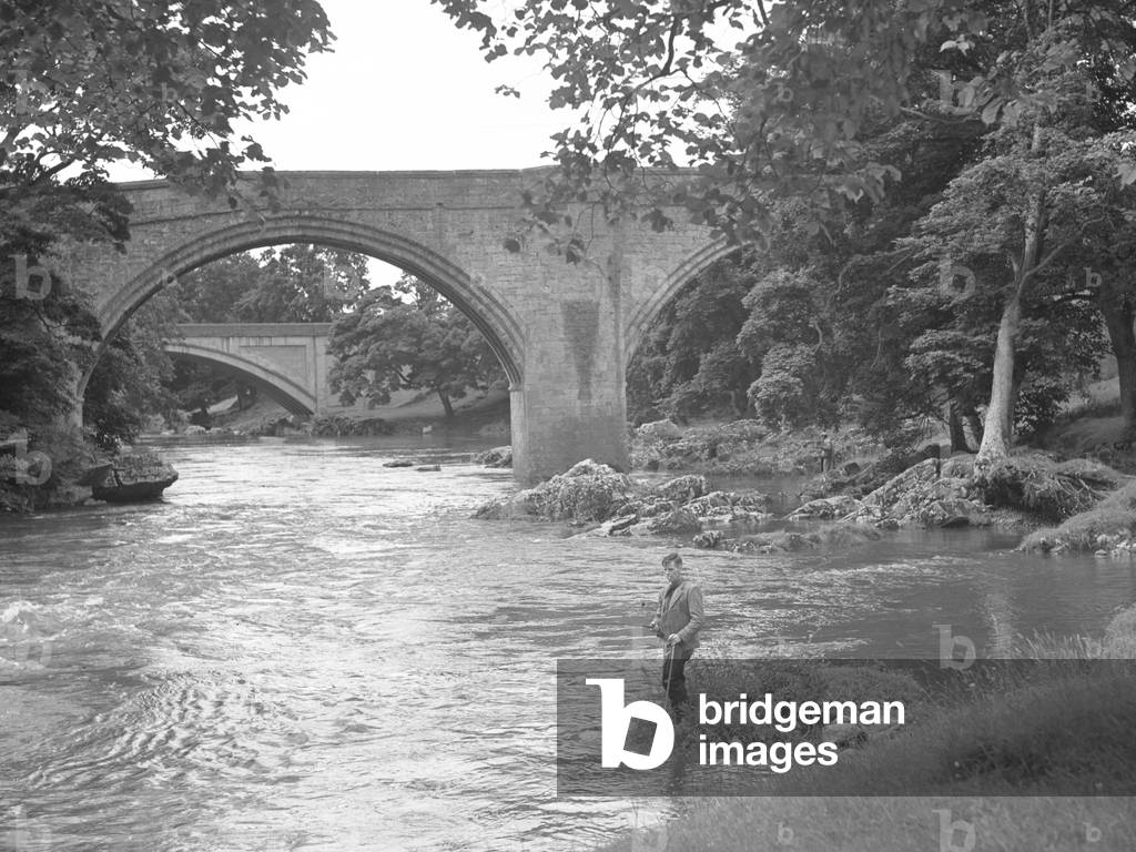 A man fishing in the river near to Devil's Bridge, 1930s-60s (b/w photo)