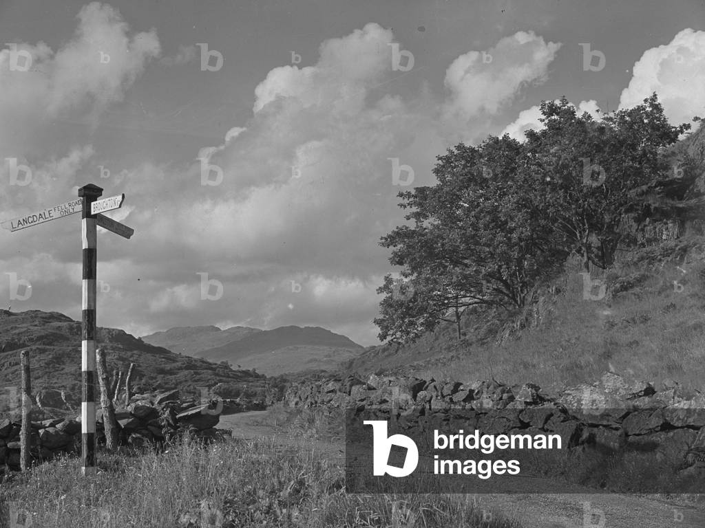 Signpost for Langdale, Broughton and Coniston at side of road, 1930s-60s (b/w photo)