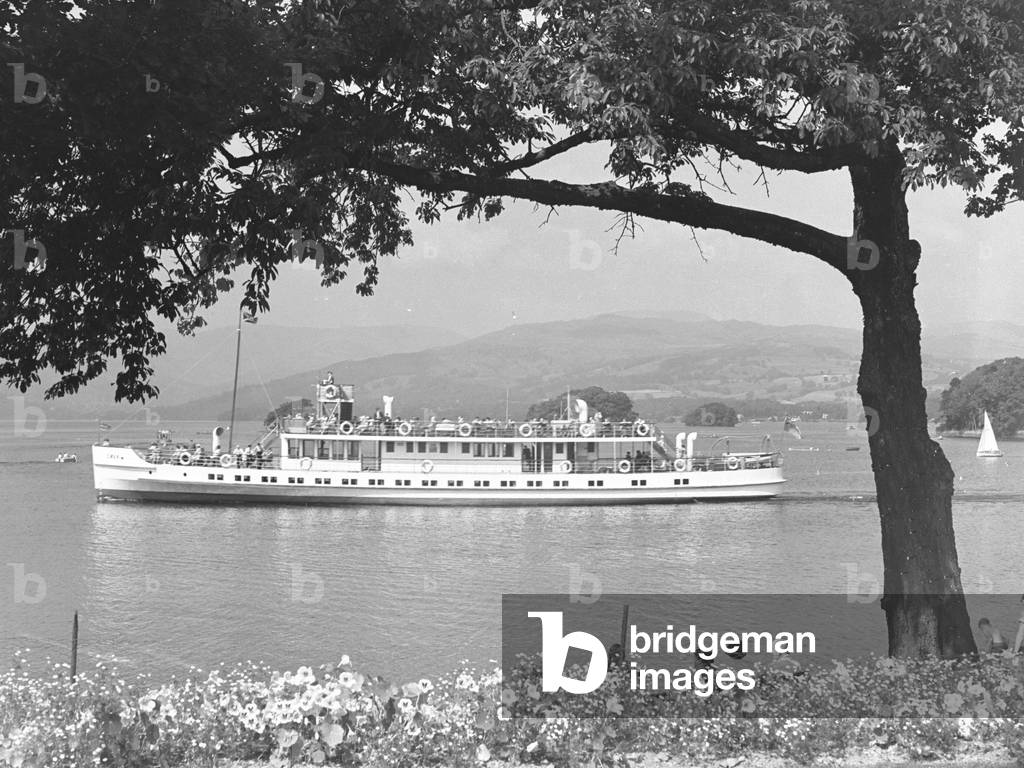 Motor vessel Swan on Windermere sailing from right to left with flowers in foreground, 1930s-60s (b/w photo)