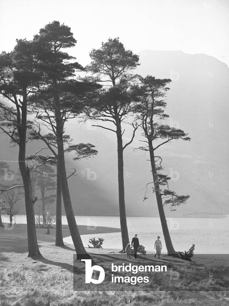 Man, woman and child walking along Buttermere shore, 1930s-60s (b/w photo)