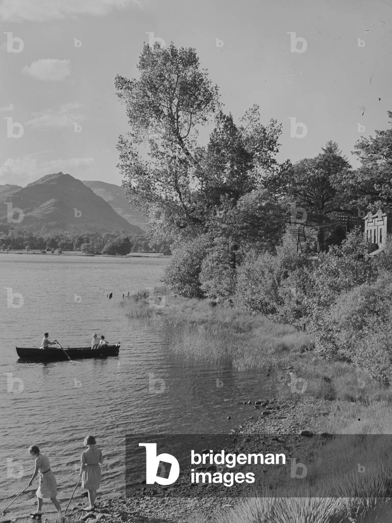Rowing boat on water at Grasmere with shore and (Banerigg?) Guest House to right of image, 1930s-60s (b/w photo)