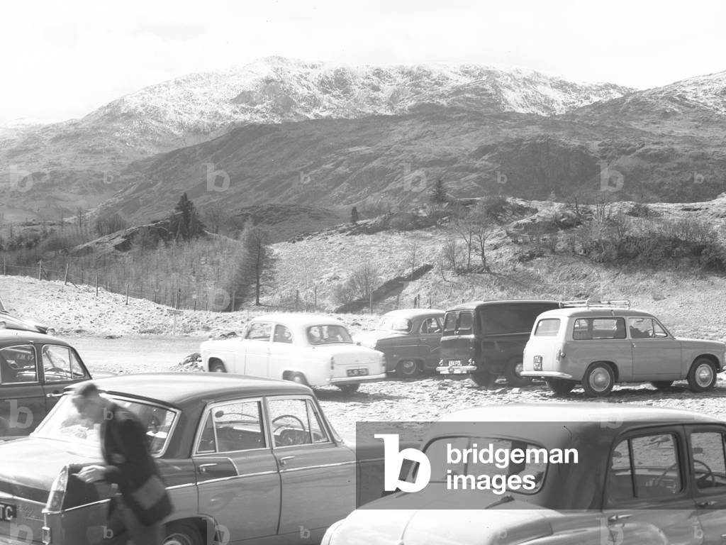 A view of cars parked up and fells in the background, 1930s-60s (b/w photo)