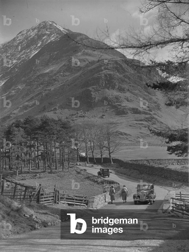 Cars on the road at Buttermere, 1930s-60s (b/w photo)