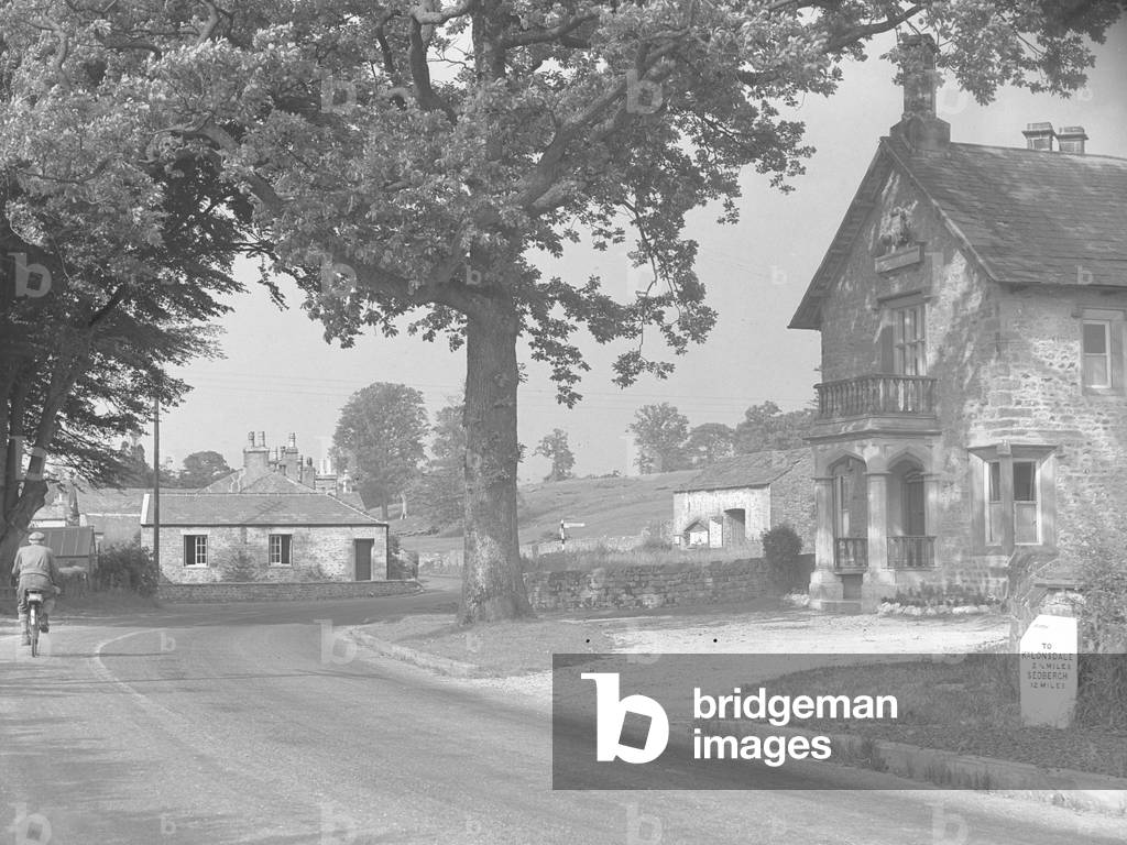 A view of various buildings and roadsigns in a village, 1930s-60s (b/w photo)