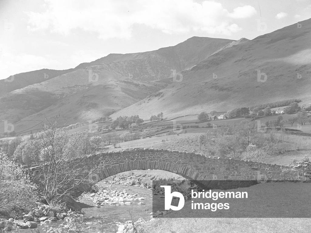 Dobson Bridge over shallow stream with fells behind, 1930s-60s (b/w photo)