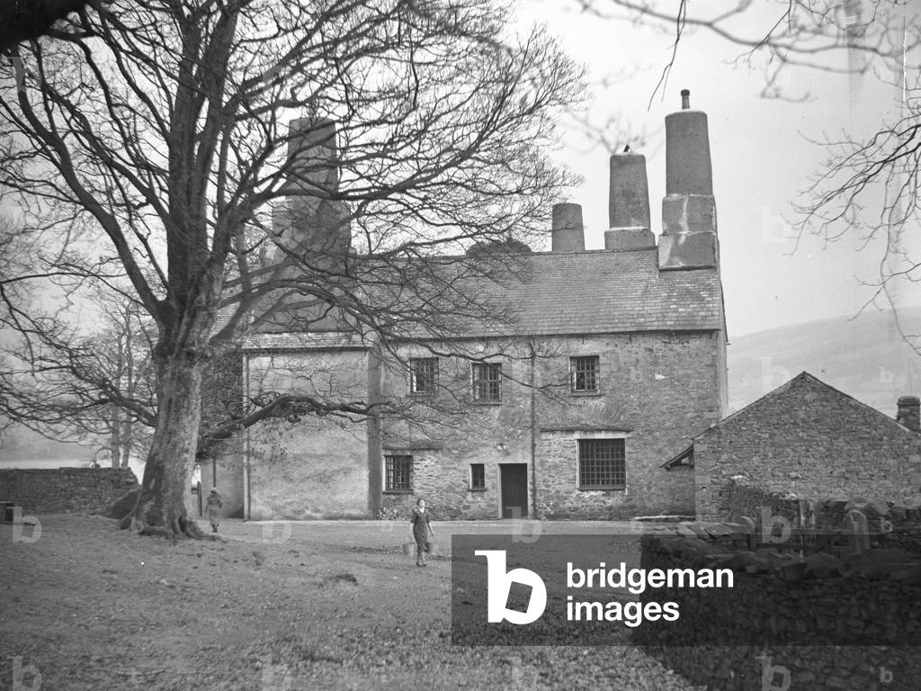 View of Coniston Old Hall with girl carrying buckets in front, 1930s-60s (b/w photo)