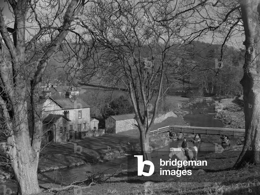 View of village of Maulds Meaburn with rider and trees in foreground, 1930s-60s (b/w photo)