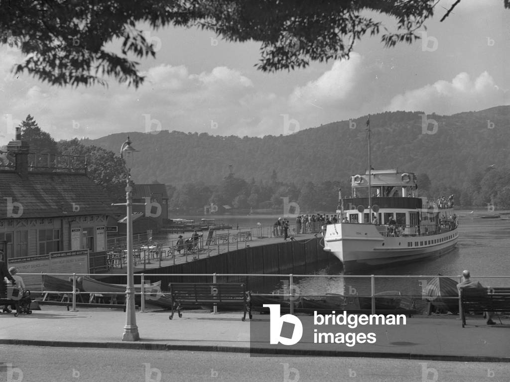 Teal at steamer pier in Bowness with boathouses to left of image, 1930s-60s (b/w photo)