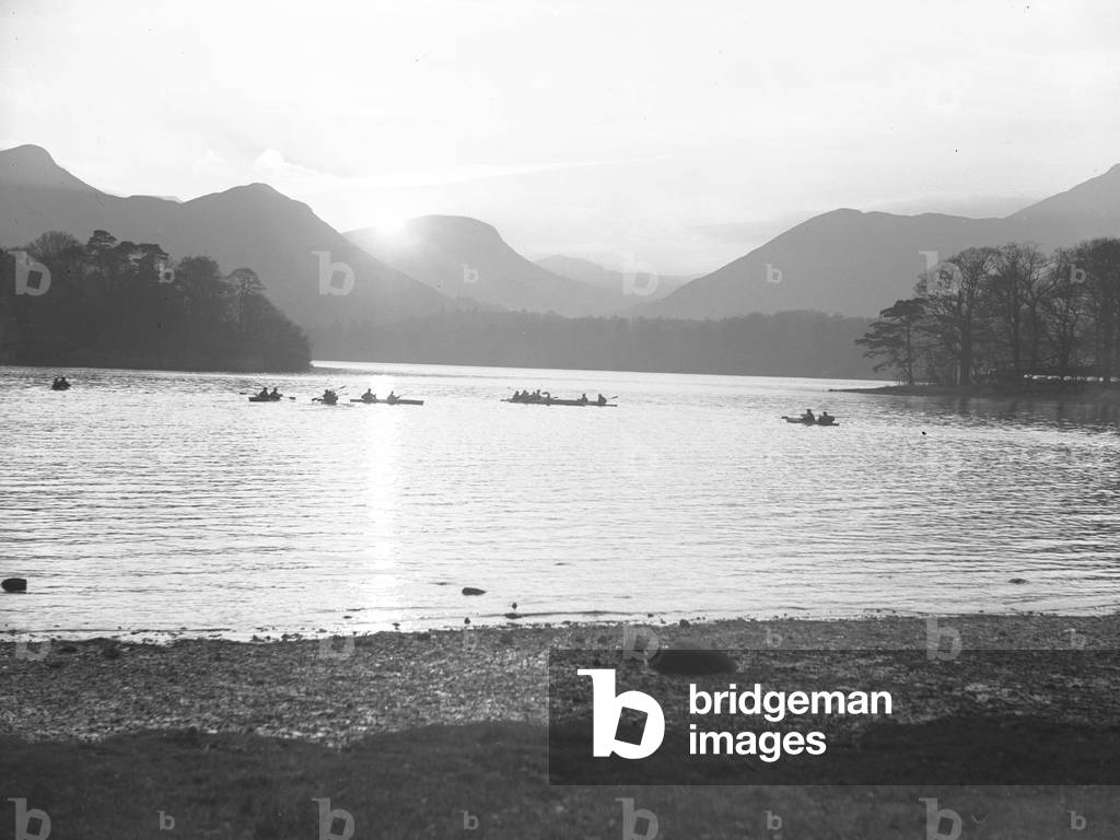 A view of people canoeing on Derwentwater at either sun rise or sun set, 1930s-60s (b/w photo)