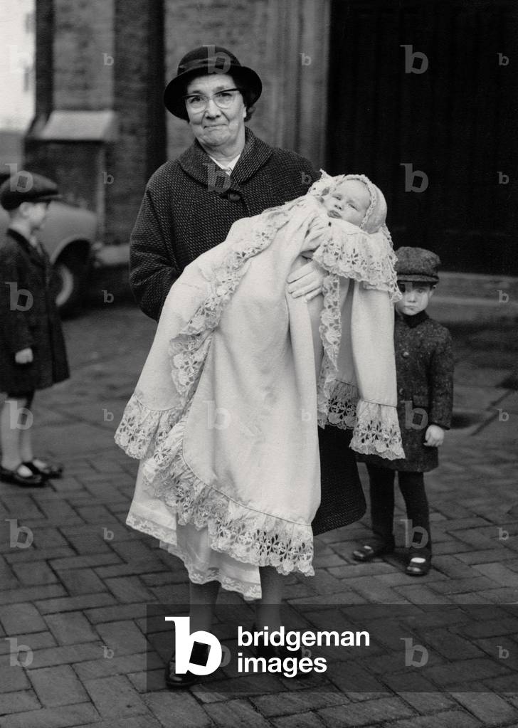 English nanny and her youngest charge, at his Christening, 1968 (photo)