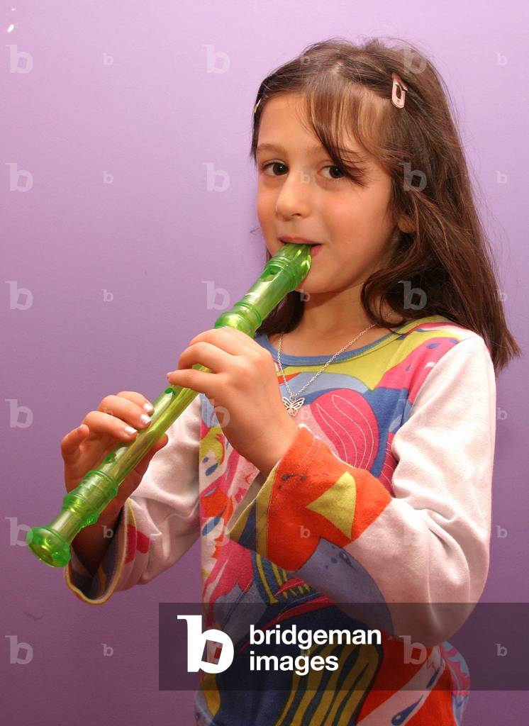 Young girl playing recorder