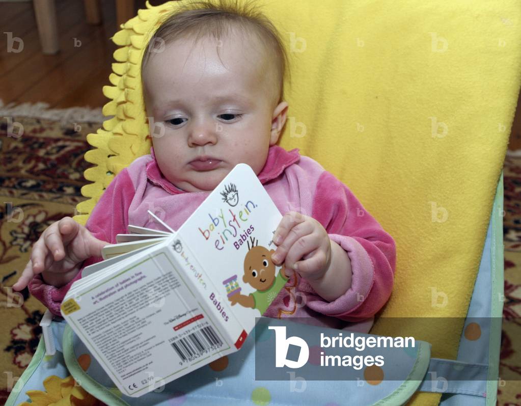 Baby reading her first book at five months. Tara Dujmovic.