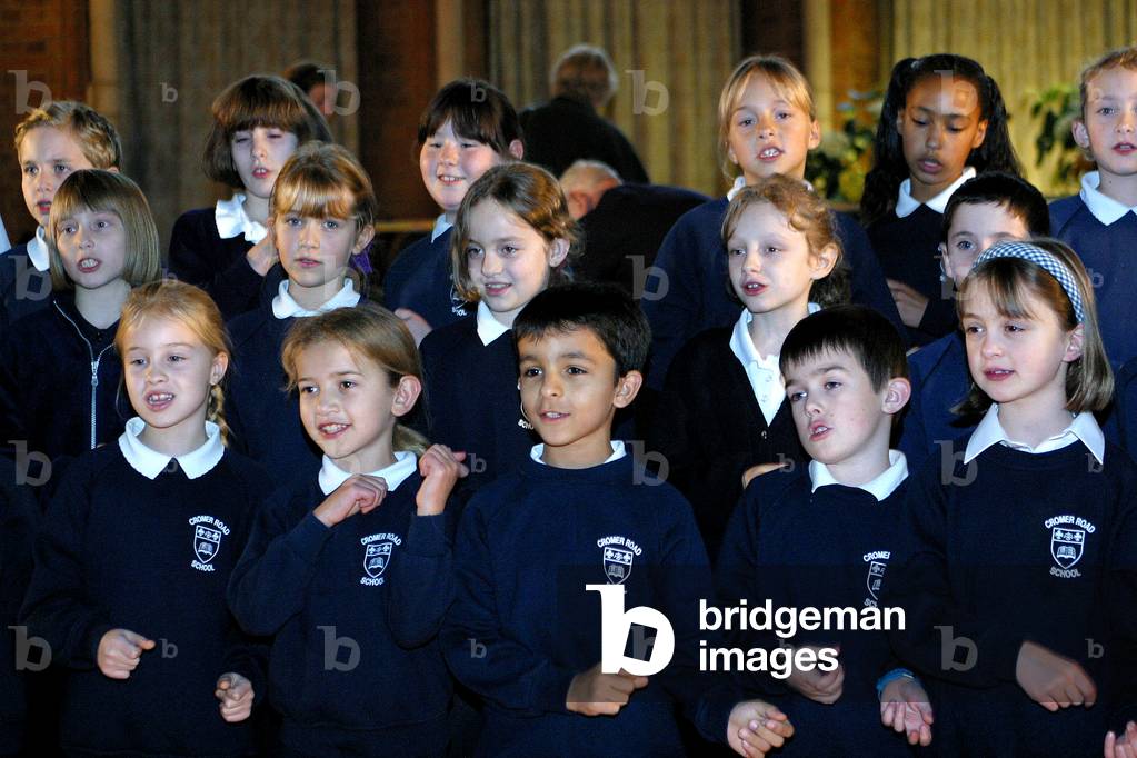 Cromer Road School Choir singing in North London. UK children in school uniforms.