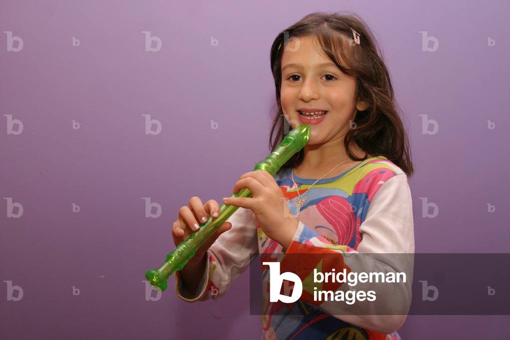 Young girl playing recorder