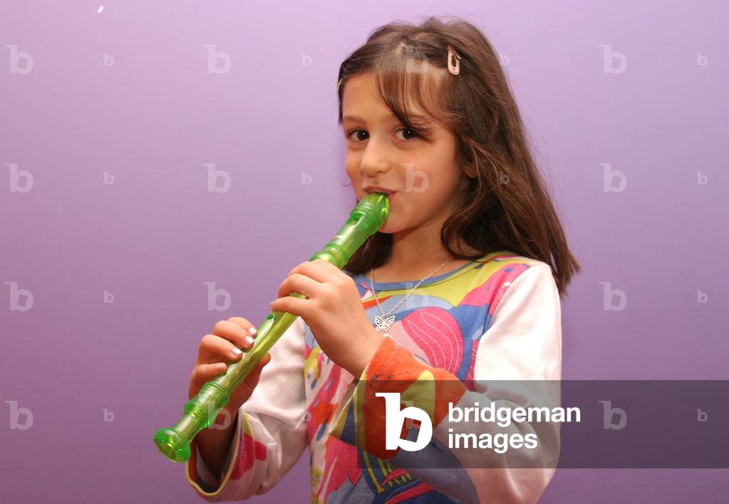 Young girl playing recorder