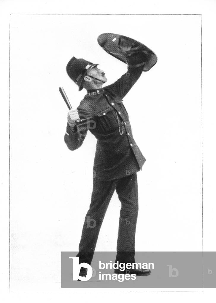 Pelted from the Roof - A policeman with a riot shield, 1912 (b/w photo)