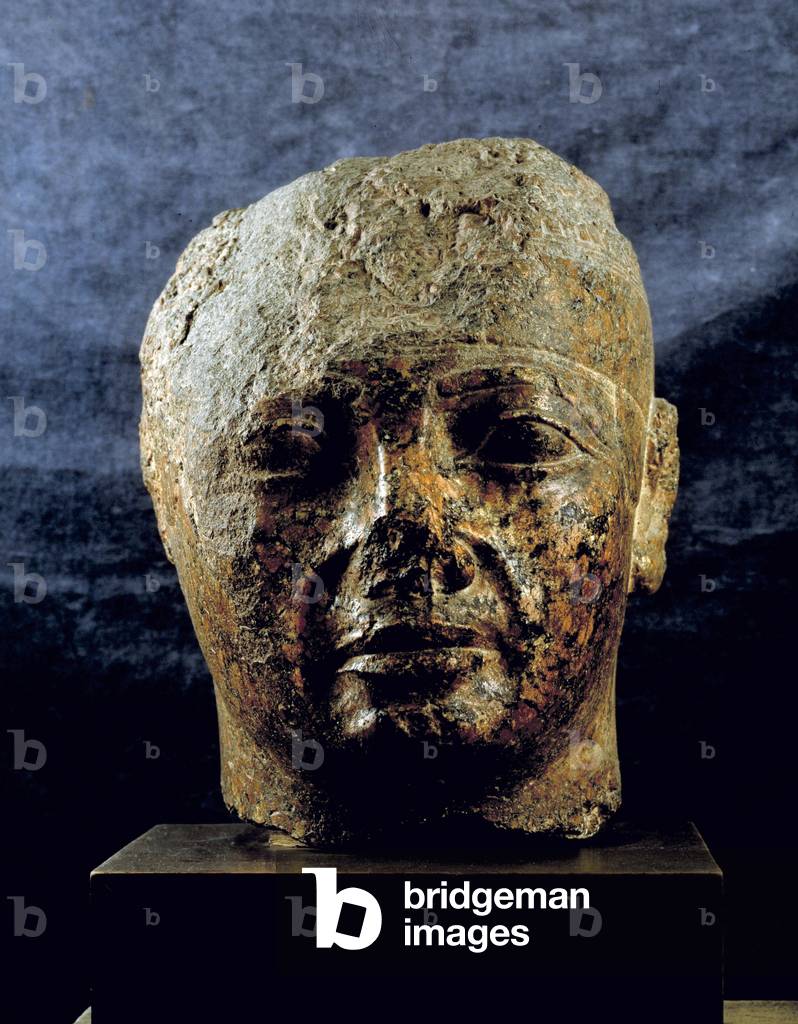 Egyptian antiquite: red granite head of Nubian king Taharka (or Taharqa). 25th dynasty, 3rd intermediate period. Museum of Egypt, Cairo