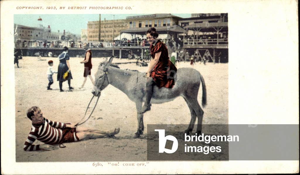 Oh, come off, man in striped shirt, woman rides donkey, beach, USA