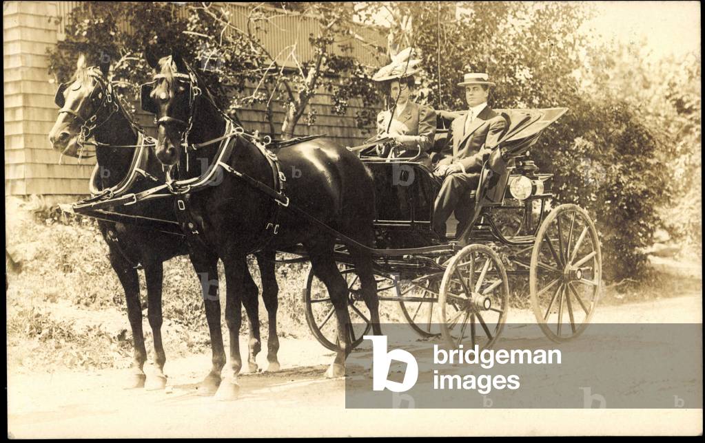 Couple in a carriage with two black horses