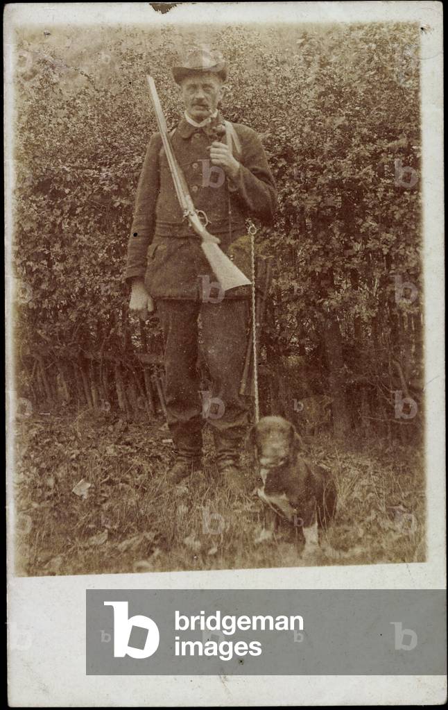 Photo Hunter with rifle and pipe, dachshund, hunter hat