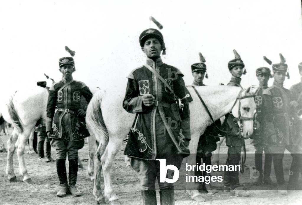 Men in riding uniform and jodhpurs wearing tasselled kepis, with horses, part of the Shah's bodyguard, Persia, Iran, 1931 (photo)