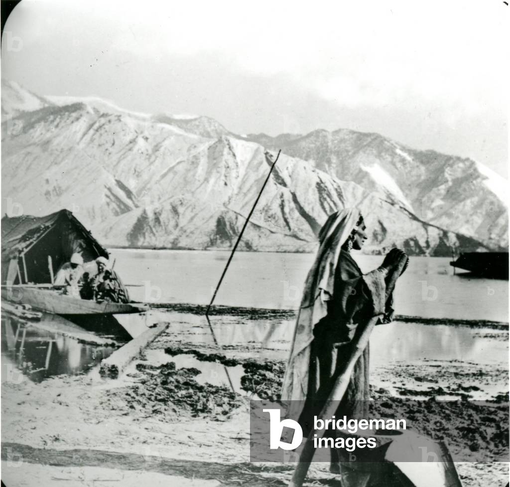 Woman pounding rice, Kashmir, India, c. 1900-1930 (photo)