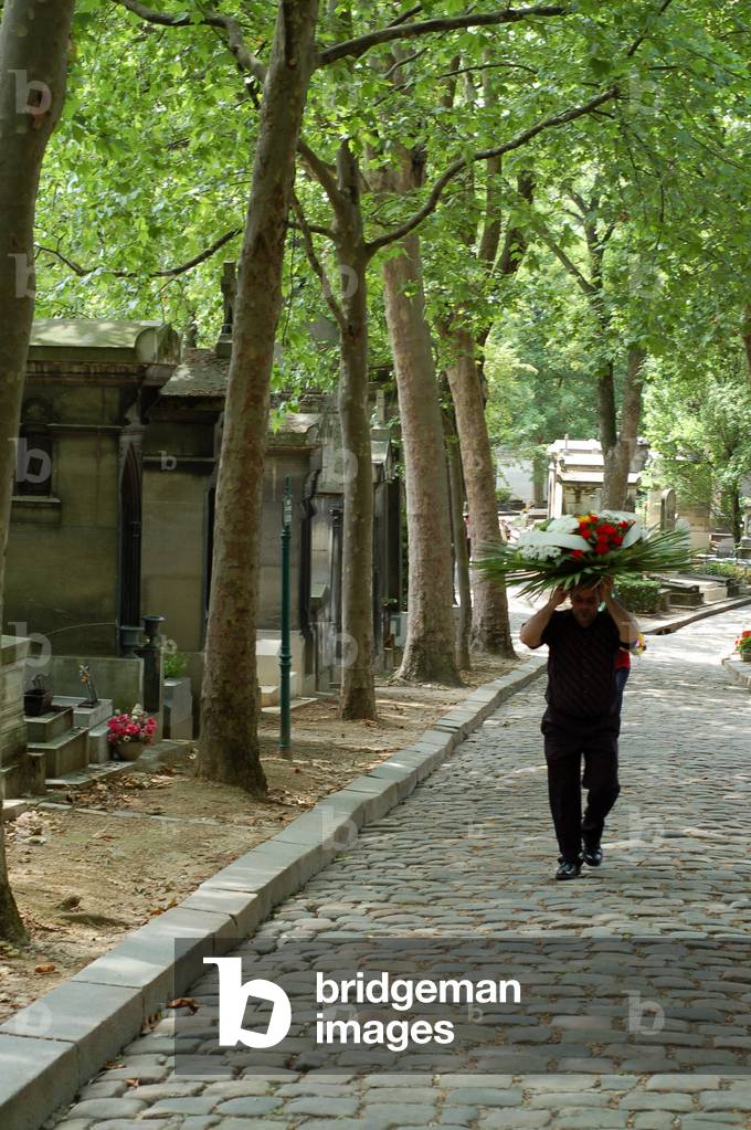 Man wearing a funeral crown, Pere Lachaise cemetery, Paris.