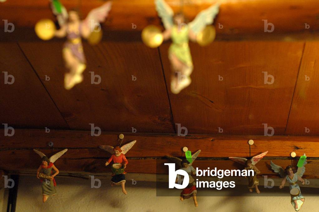 Christmas decorations shop: angels with price tag in euros. Naples, Italy.