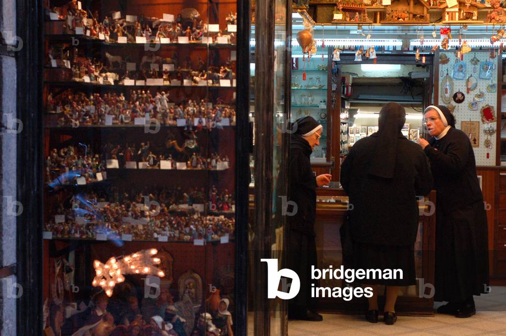 Nuns in a Christmas decorations shop, Naples, Italy.