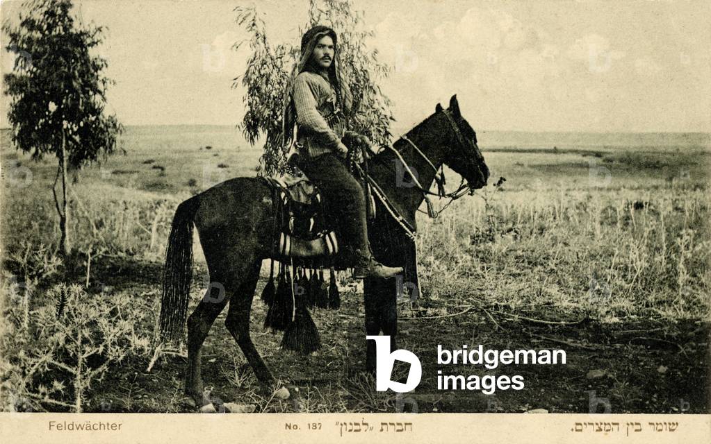 Palestinian watchman  of Jewish Russian origin wearing Arab headscarf and riding a horse