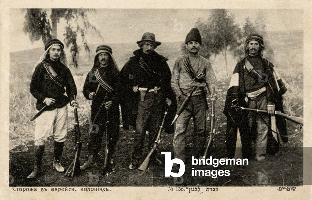 Palestinian watchman of Jewish Russian origin wearing Arab headscarves and carrying rifles