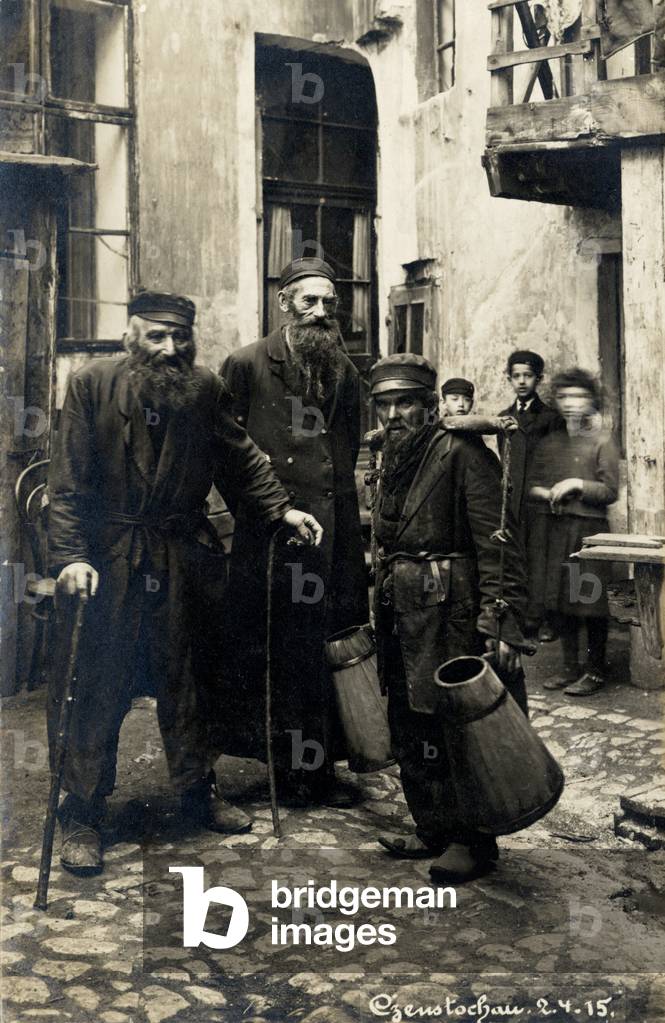 Water-carrier in Czenstochova (Czenstochau) in Poland in 1915 small cobbled street with children in background