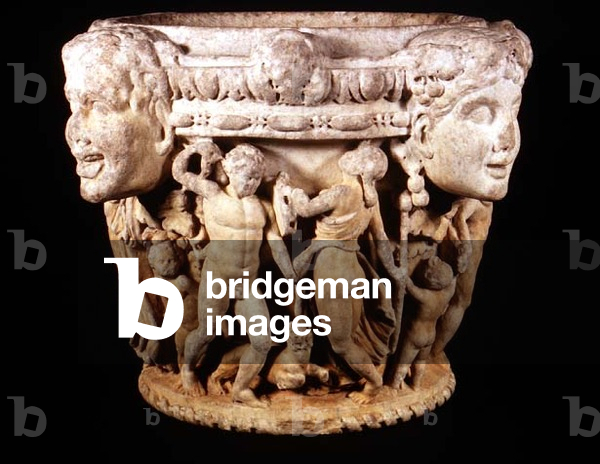 Carved column capital depicting Eros watching a nude youth, possibly Dionysus, dancing with a maenad who holds a tambourine, the rim decorated with heads of Dionysus and satyrs, Italian, from rome, c.180-220 (marble, pentelic Greek or Italian Carrera) (see also 83317-20)