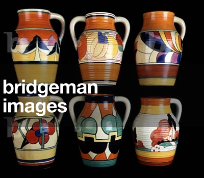 (LtoR) An 'Orange Luxor' pattern single handled Lotus jug, a 'Melon' pattern two handled Lotus Jug, a 'Swirls' pattern single handled Lotus jug, a 'Picasso Flower' pattern single handled Lotus jug, a 'Castellated Circle' pattern two handled Lotus jug and a 'Farmhouse' pattern single handled Lotus jug (ceramic)