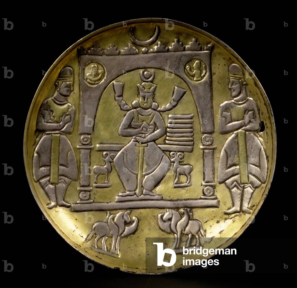 Dish depicting an enthroned king flanked by two small ibex seated in a pavilion supported by two winged horses with two attendants, on a ring base, Sasanian (3rd-7th centuries AD) (silver-gilt)