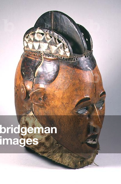 Dance head-dress with two opposing heads and a crest with three ridges, the base with hide attachment from the Ekoi tribe of the African Guinea Coast (leather, wood, hide)
