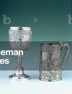 (LtoR) Chinese export goblet embossed and chased with Chinese characters, pagodas and bamboo shoots; Chinese export mug made by Leeching (fl.1850s) with embossed decoration of a battle scene, the handle in the form of a dragon, 19th century (silver) (see also 93404)