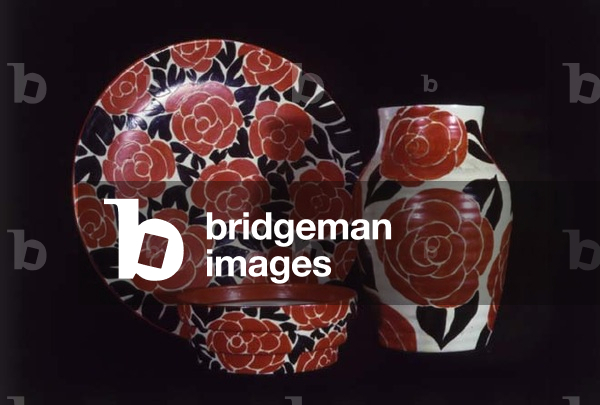 (LtoR) A 'Latona Red Roses' bowl, wall plaque and Isis vase, by Clarice Cliff (1899-1972) (ceramic)