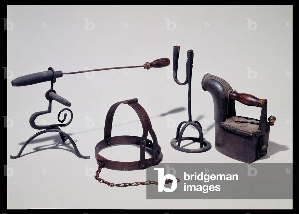 Goffering iron, early 18th century; a brank or scold's bridle; an 18th century rush light holder; an early 18th century smoothing iron
